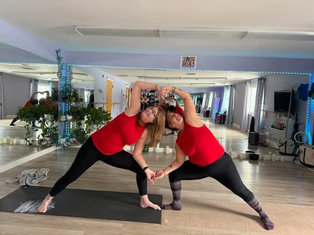 Two students in a partner side angle stretch