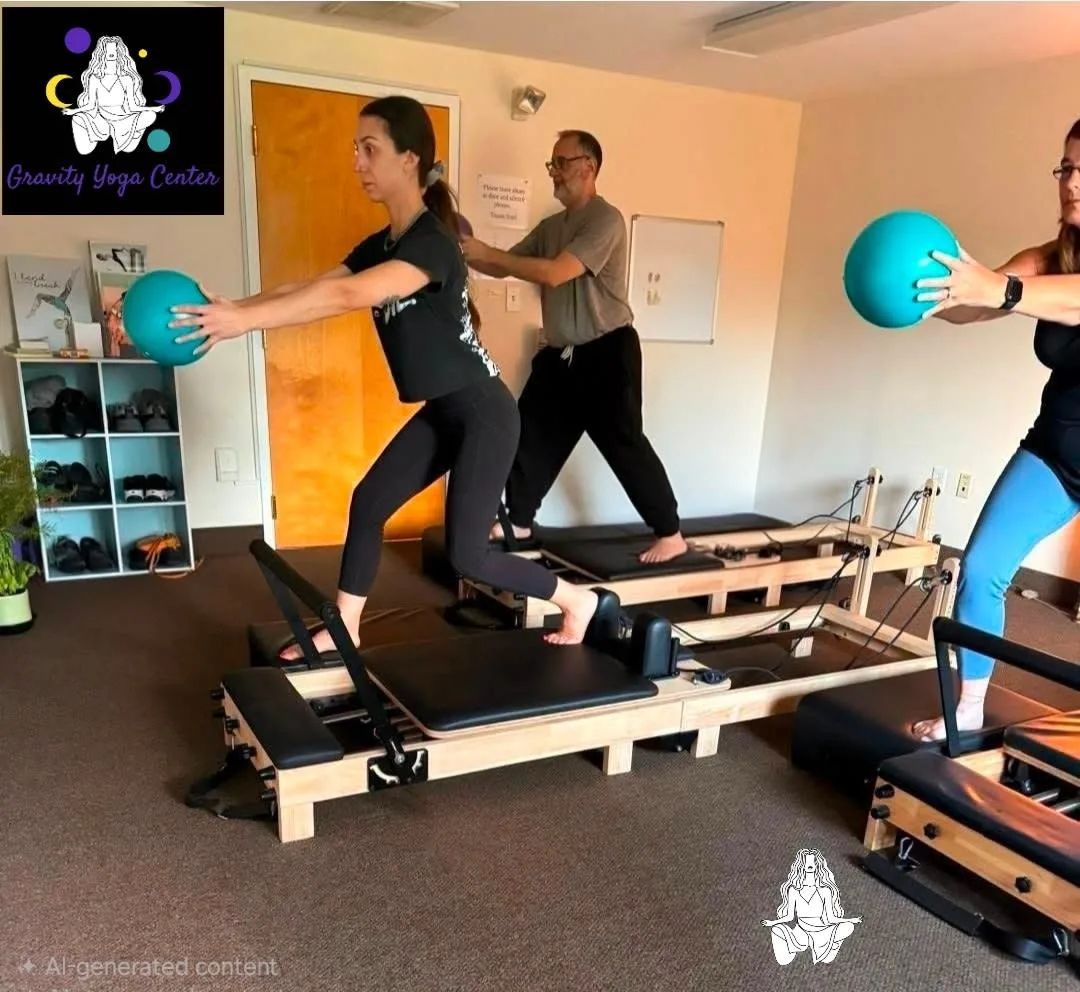 Students on Pilates reformers working with exercise balls at Gravity Yoga Center